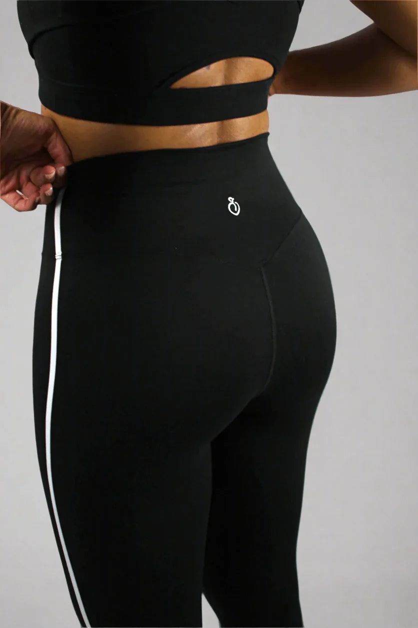 Black athletic leggings with a logo on a plain background