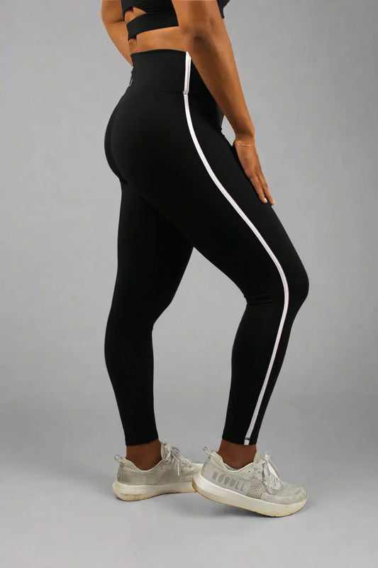 Black leggings with white stripes worn by a person on a white background