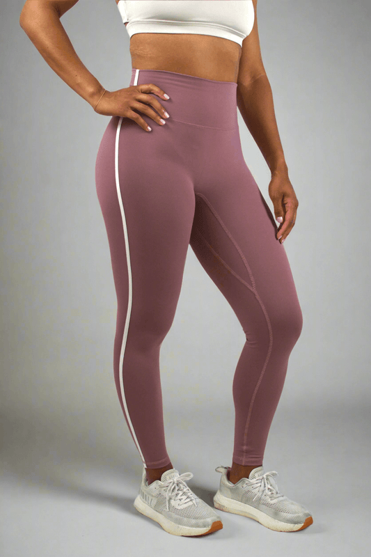 Person wearing mauve leggings with white stripe on a white background