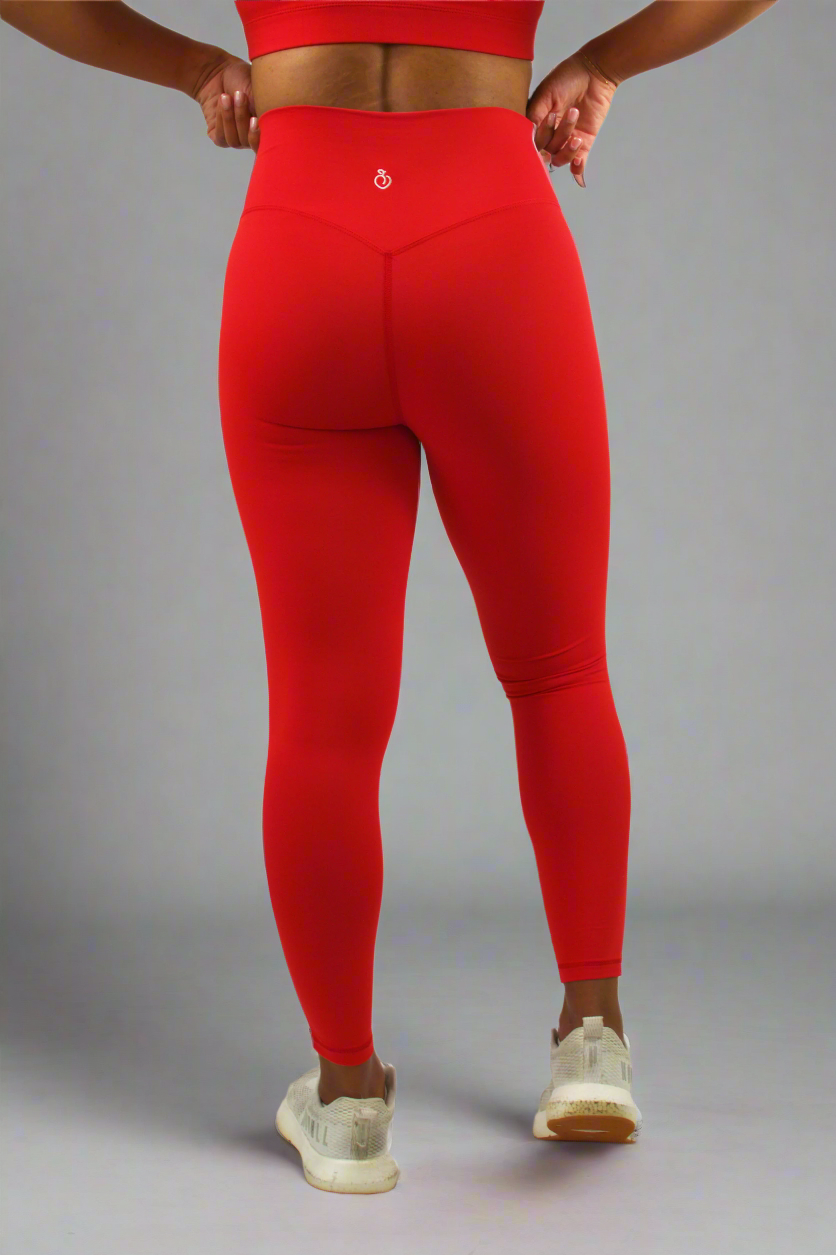 Red leggings worn by a person on a white background