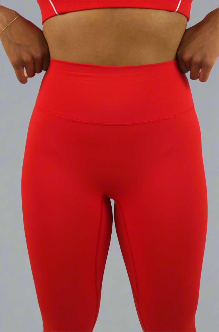 Red leggings worn by a person on a light gray background
