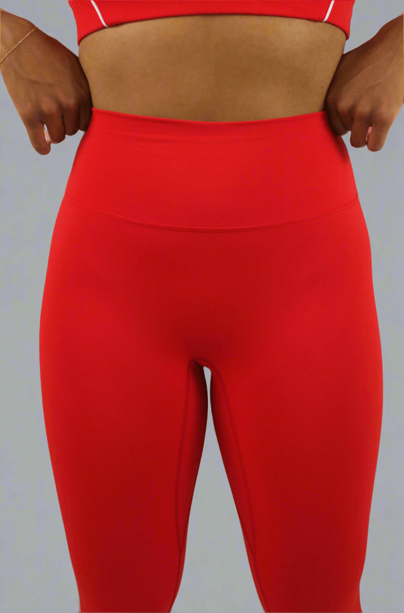 Red leggings worn by a person on a light gray background