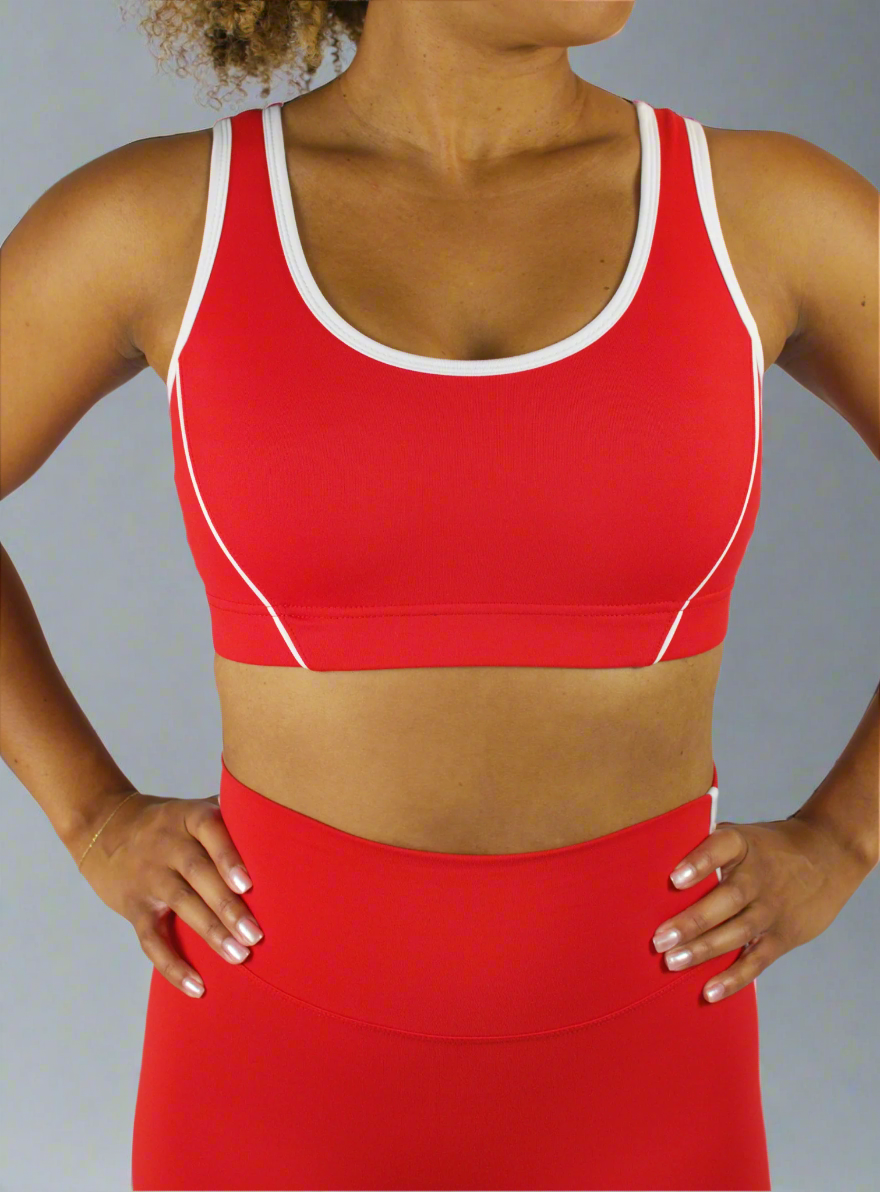 Red sports bra and leggings set on a plain background