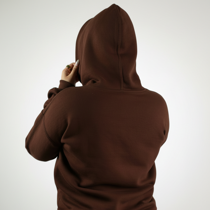Brown hoodie and pants set on a white background