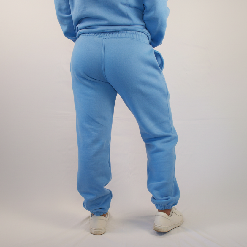 Person wearing a blue tracksuit on a white background