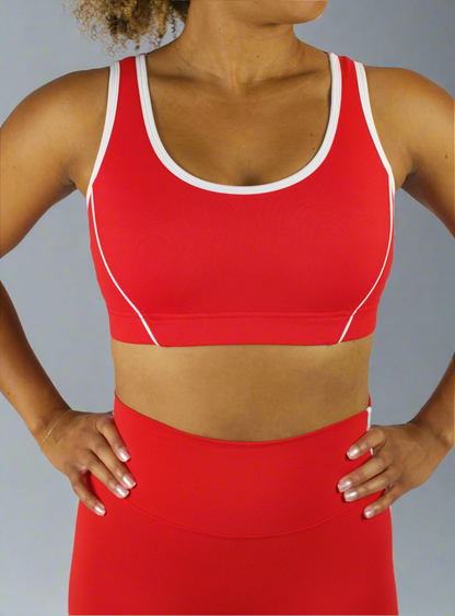 Red sports bra and leggings set on a plain background