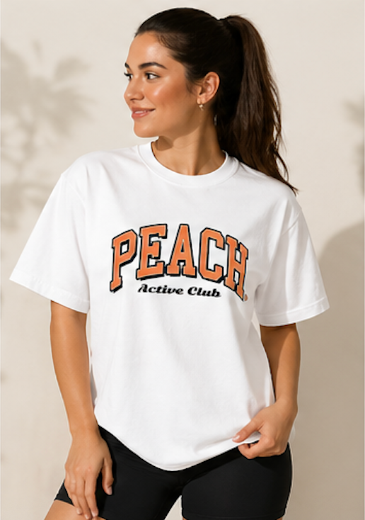Woman wearing a white t-shirt with 'Peach Active Club' text on a beige background