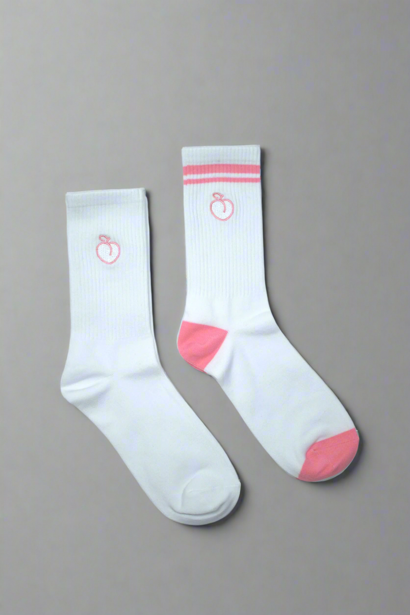 One white pair of crew socks and one pink striped pair of crew socks