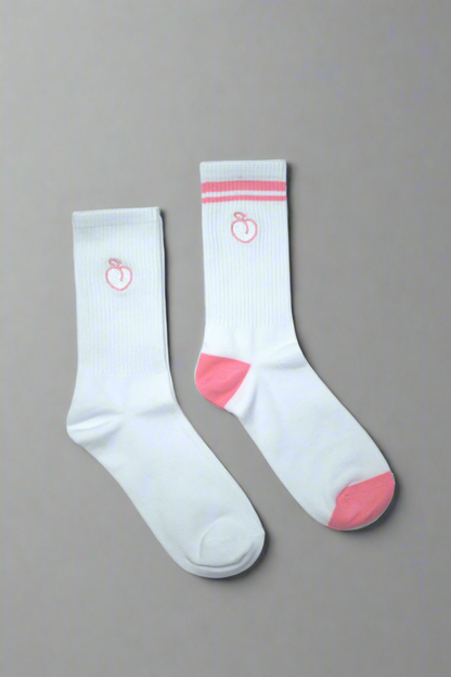 One white pair of crew socks and one pink striped pair of crew socks